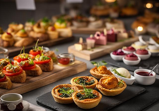 Evening Canapés spread with savoury tartlets, bruschetta and neat sweet bites on serving boards